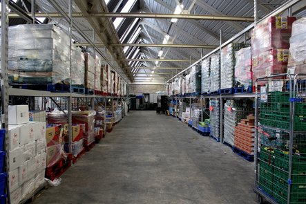 massive warehouse, divided into aisles by huge steel beams.