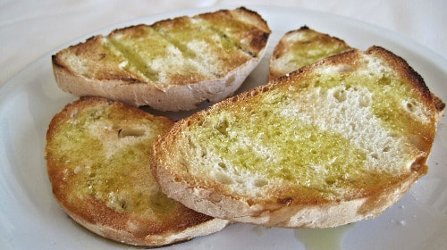 Bruschetta. White bread with a drizzle of oil, the best way to taste olive oil